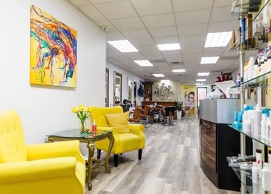 Bright salon interior at Millie's All About You in New York, New York, US showcasing colorful decor and seating.