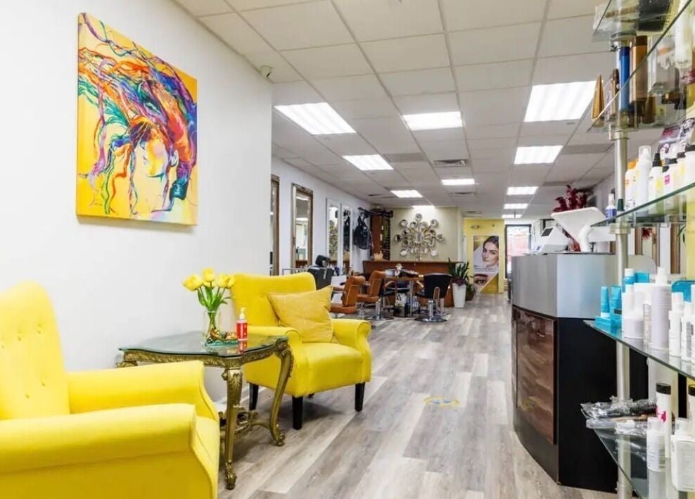 Bright salon interior at Millie's All About You in New York, New York, US showcasing colorful decor and seating.