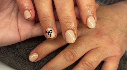 Nail art with bow design at Amber does nailz in Hamilton, Waikato Region, NZ. Elegant nude polish finish.