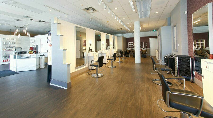 Spacious and modern salon interior at Venus Victoria Salon & Spa, Toronto, Ontario, CA, featuring stylish chairs.