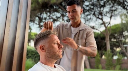 Hairstylist crafting a fresh look on a client outdoors at FICA Faded, Parede, Lisboa, PT.