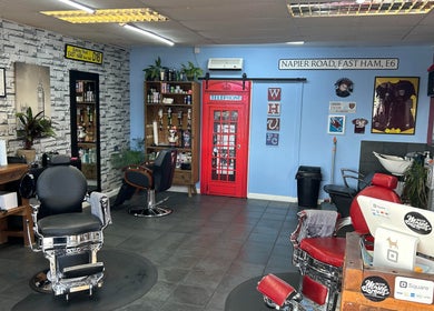Interior of The Gentlemens Room Classic Barbers in Exmouth, England, GB with vintage chairs and decor.