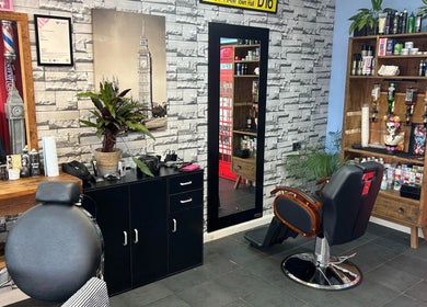 Interior of The Gentlemens Room Classic Barbers in Exmouth, England, GB. Modern chair and wall decor.