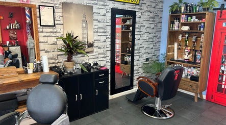 Interior of The Gentlemens Room Classic Barbers in Exmouth, England, GB. Modern chair and wall decor.