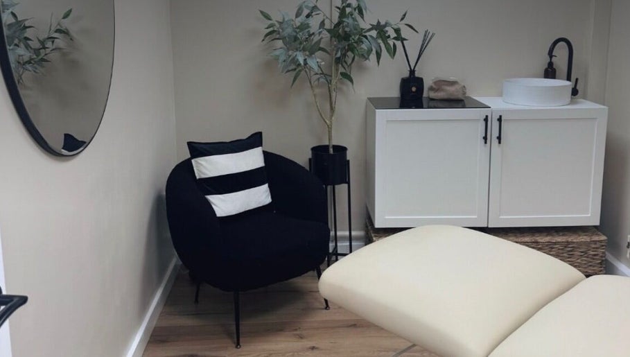 Serene Skin Clinic's relaxing treatment room in Billingham, England, GB, featuring modern decor and comfy seating.