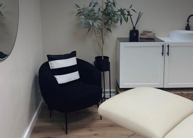 Serene Skin Clinic's relaxing treatment room in Billingham, England, GB, featuring modern decor and comfy seating.