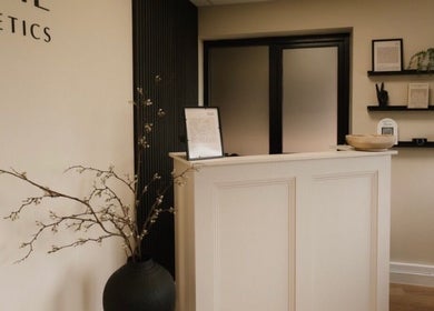 Reception at Serene Skin Clinic, Billingham, England, GB. Minimalist decor with shelves and elegant vases.