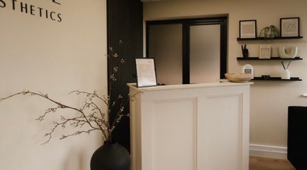 Reception at Serene Skin Clinic, Billingham, England, GB. Minimalist decor with shelves and elegant vases.
