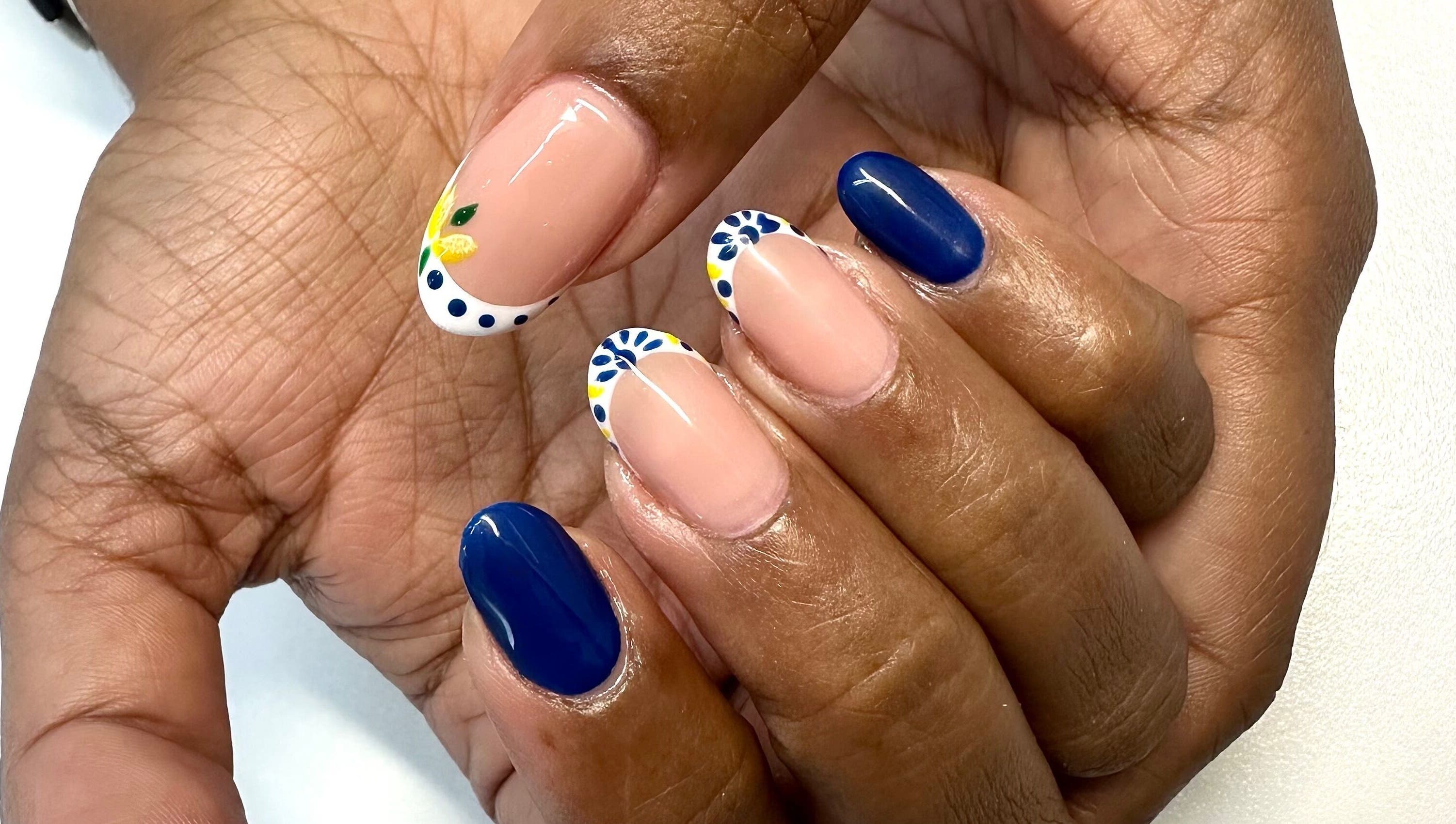 Bright nail art at LuBella Beauty in Waterfall, Kwazulu-natal, ZA showcasing floral and blue designs.
