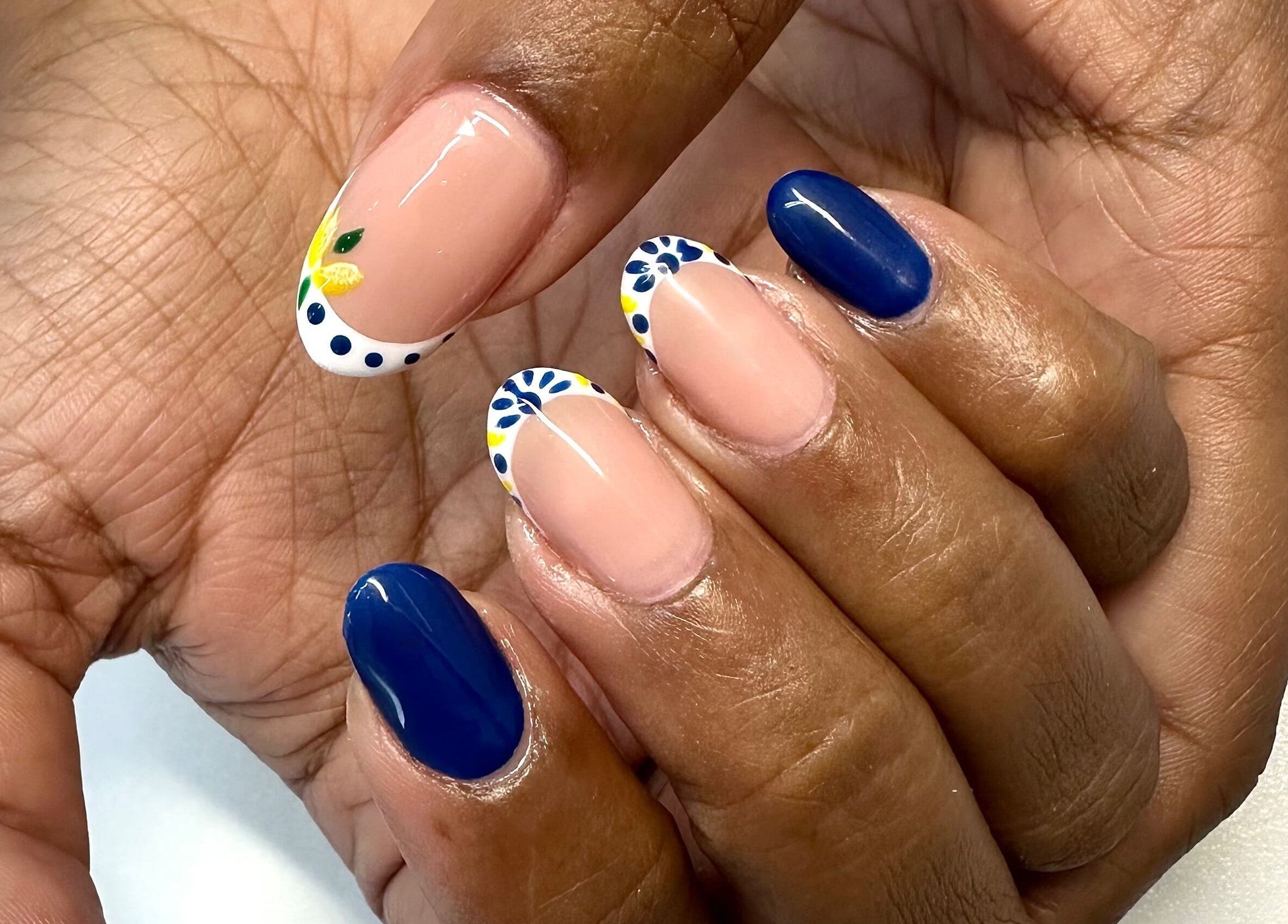 Bright nail art at LuBella Beauty in Waterfall, Kwazulu-natal, ZA showcasing floral and blue designs.