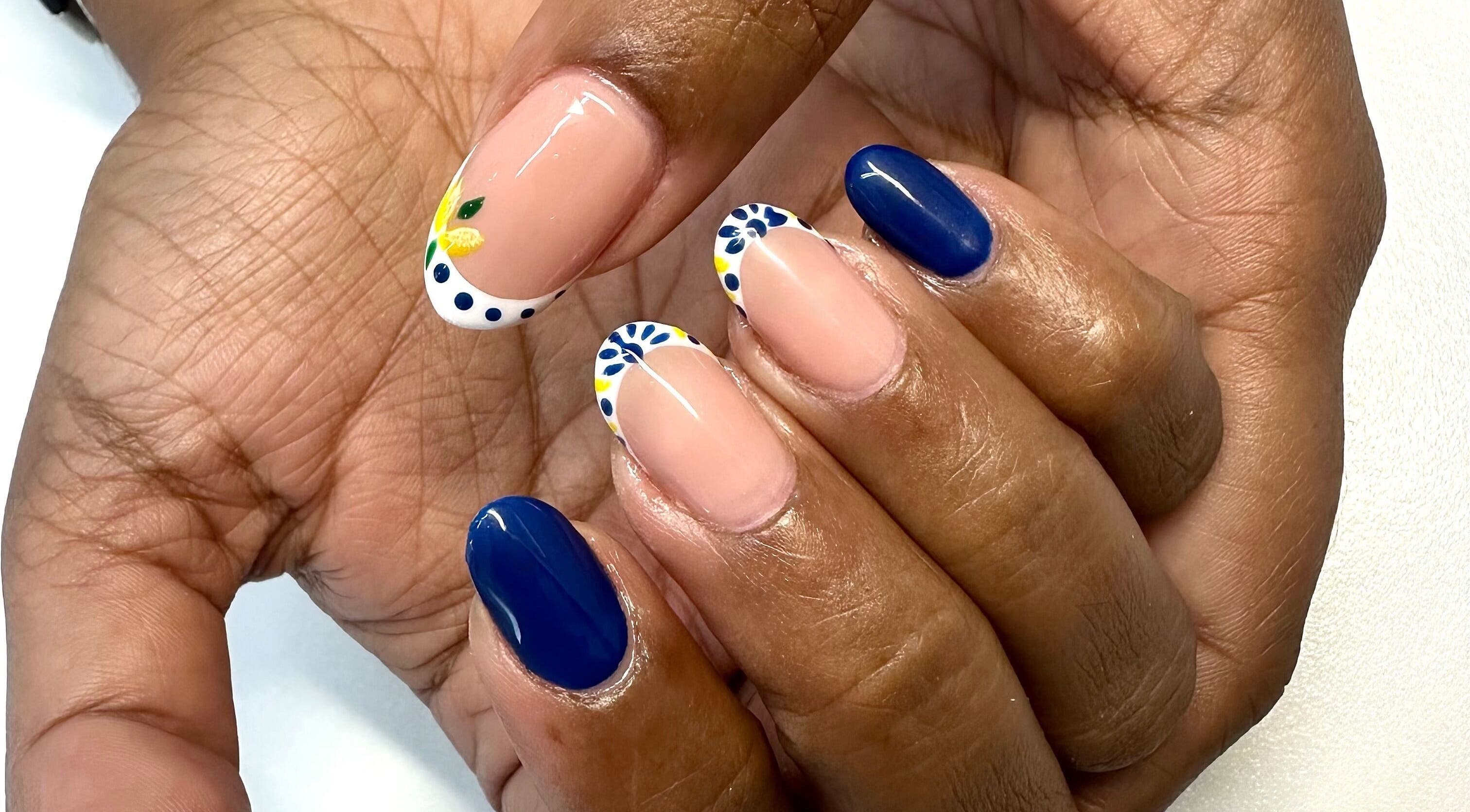 Bright nail art at LuBella Beauty in Waterfall, Kwazulu-natal, ZA showcasing floral and blue designs.