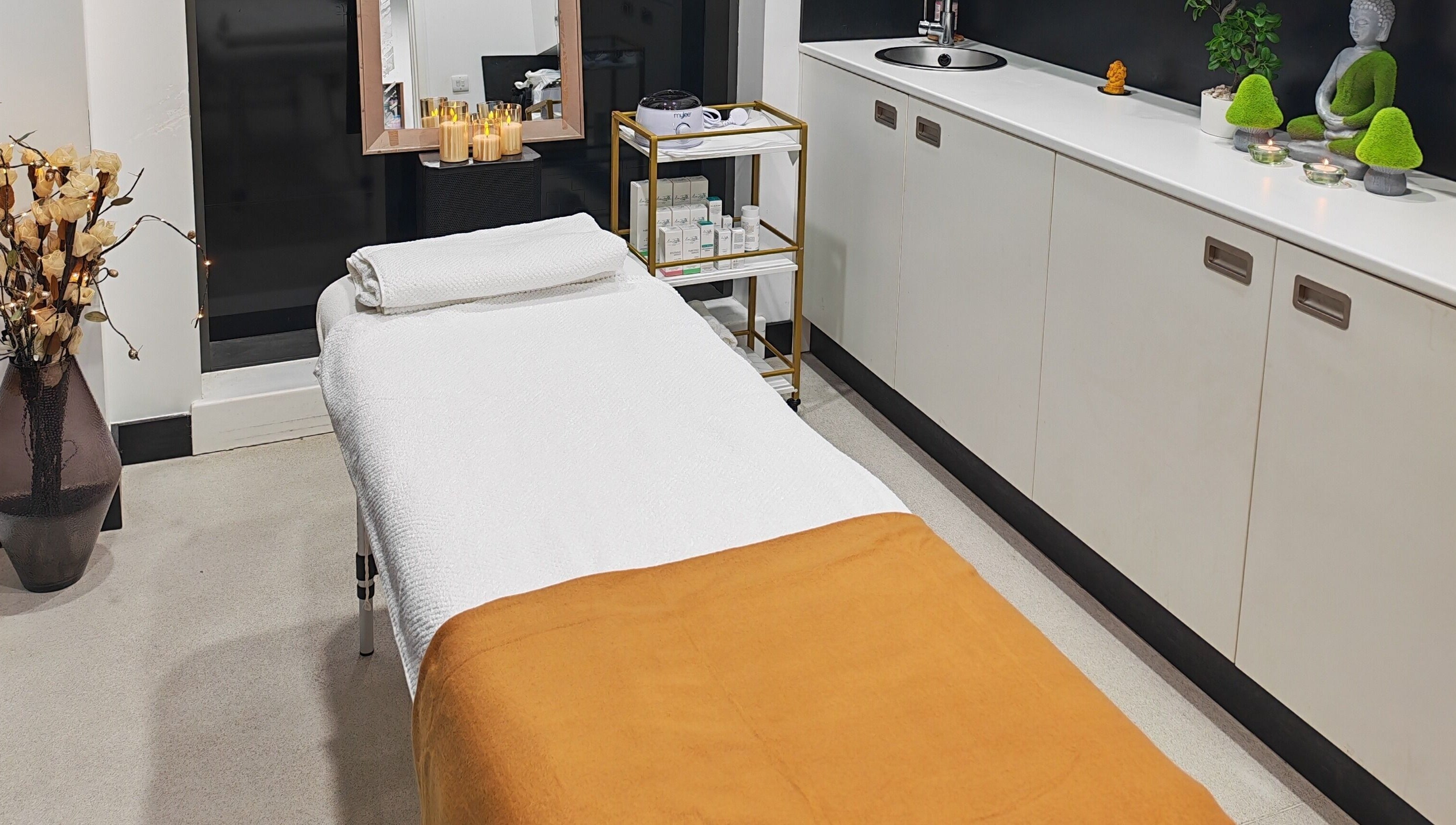 Relaxing massage room at Aura Hair N Beauty, London, England, GB, with a comfy table and calming decor.