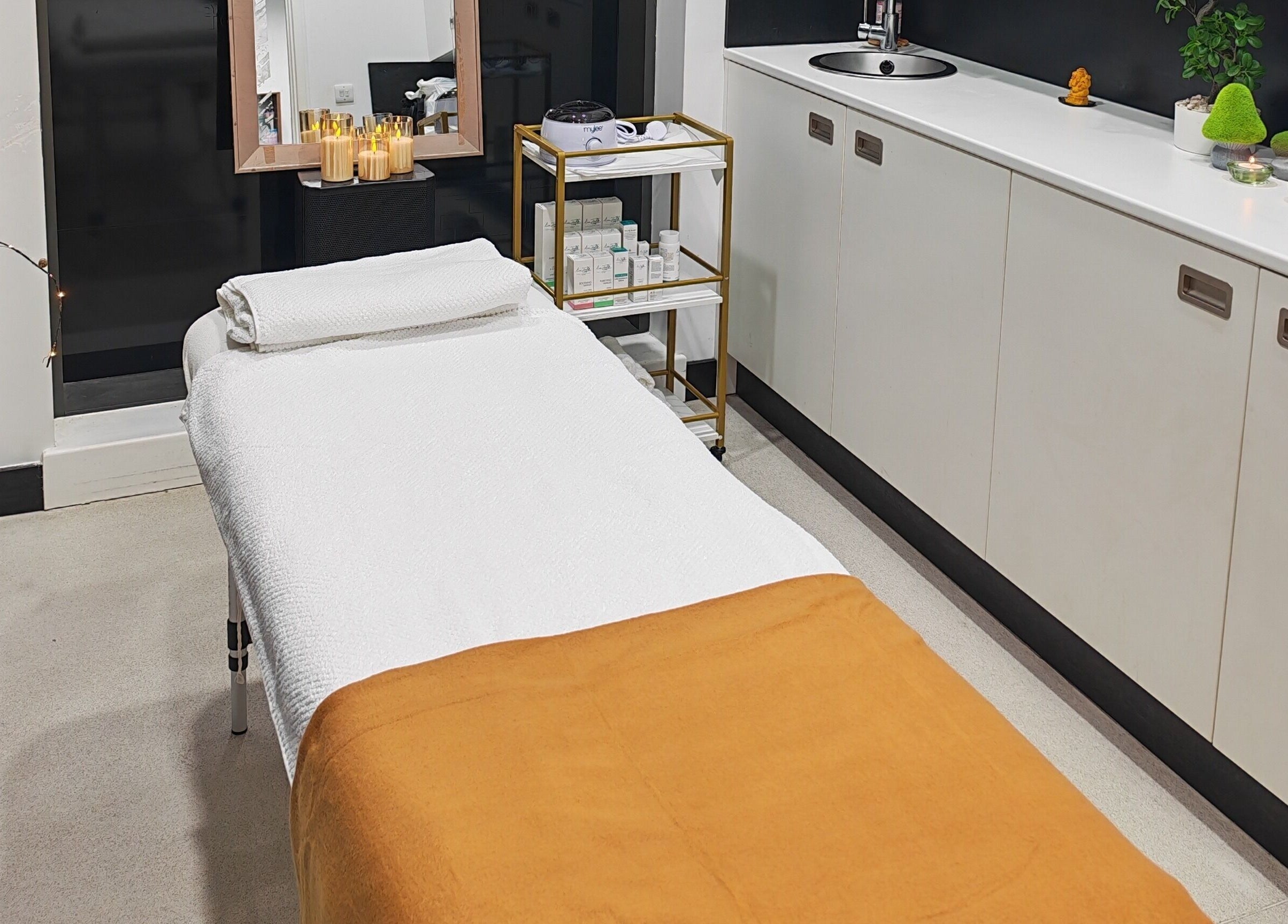 Relaxing massage room at Aura Hair N Beauty, London, England, GB, with a comfy table and calming decor.