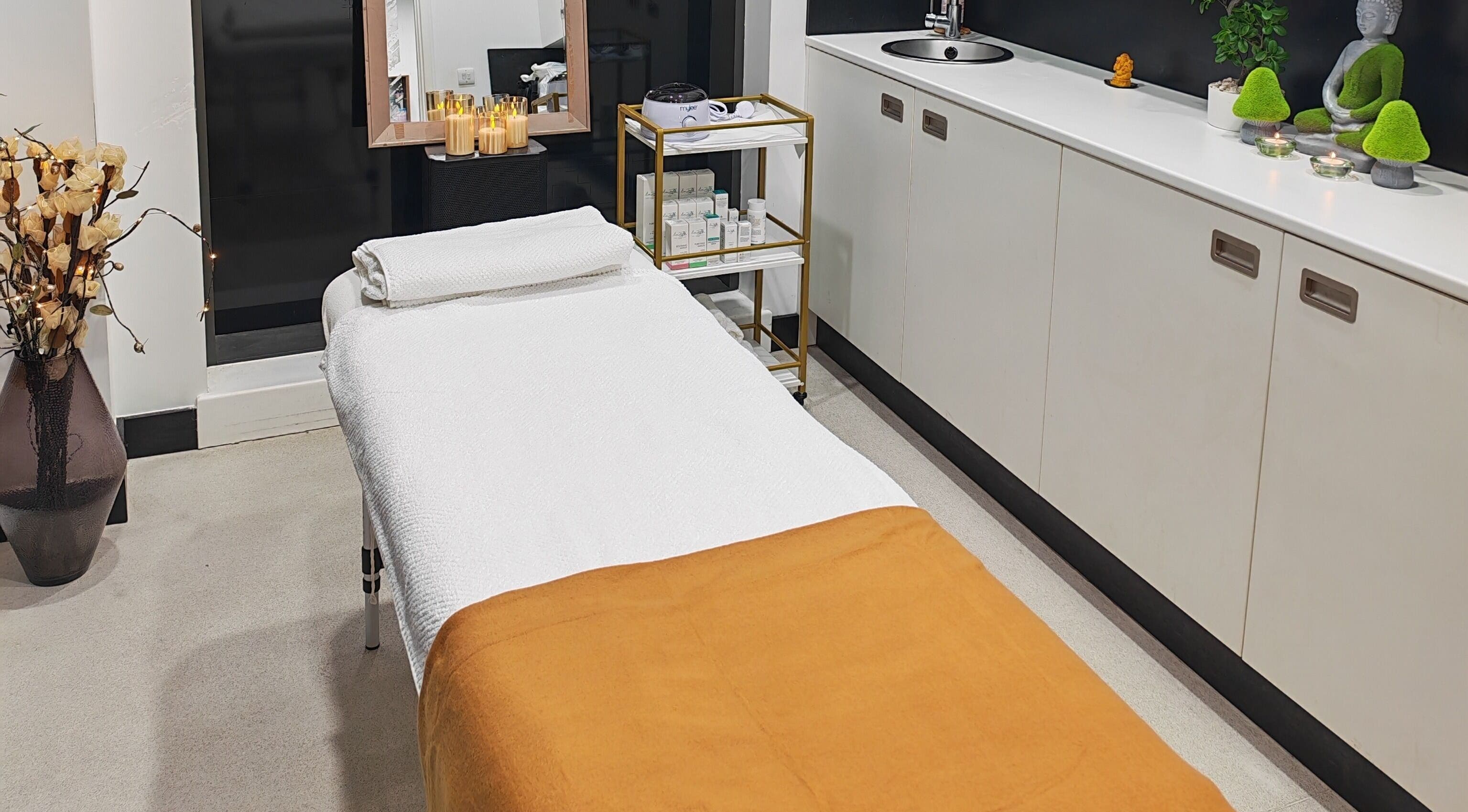 Relaxing massage room at Aura Hair N Beauty, London, England, GB, with a comfy table and calming decor.