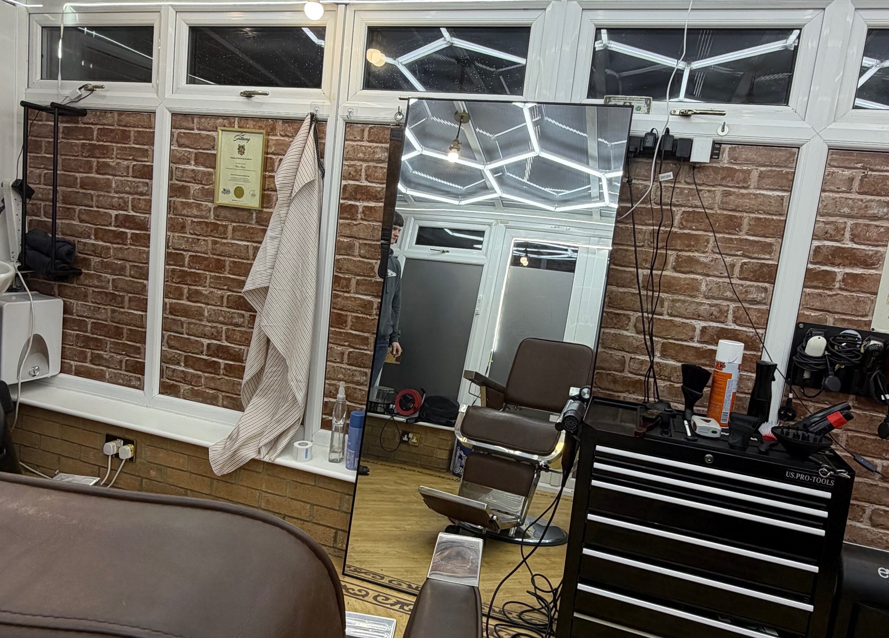 Interior of No45 Bespoke Barbering in Emneth, England, GB with vintage barber chair and modern tools.