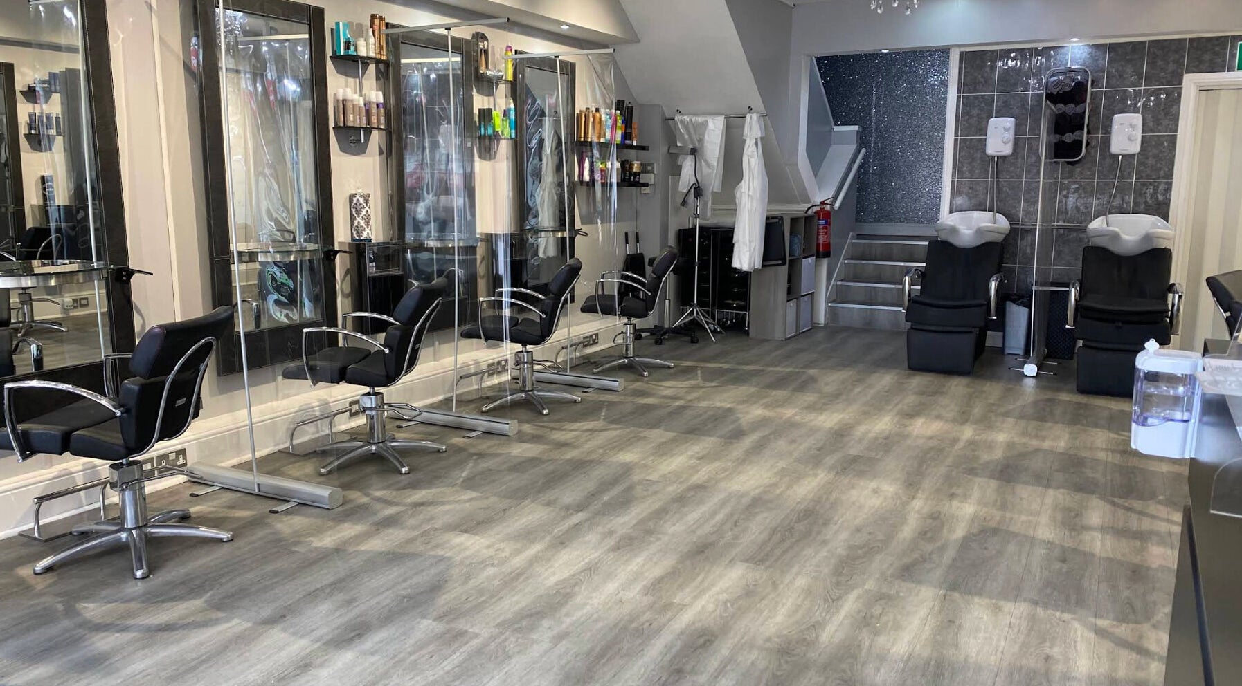 Modern interior of Spectrum Hair, Tanning & Beauty Salon in Welwyn Garden City, England, GB with stylish chairs.
