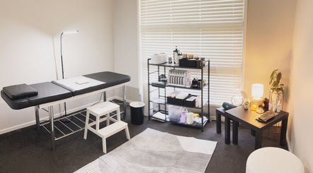 Serene Butterfly Beauty treatment room in Pimpama, Queensland, AU, featuring a massage table and ambient lighting.