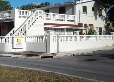Charming exterior of Glazedpalace.bb in Fitts Village, Saint James, BB with white balustrades.