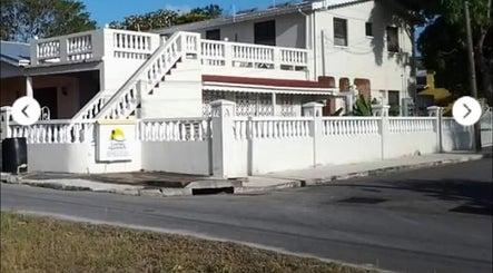 Charming exterior of Glazedpalace.bb in Fitts Village, Saint James, BB with white balustrades.
