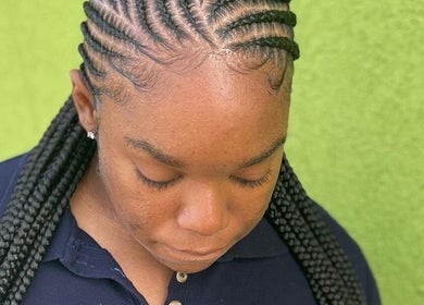 Intricate braided hairstyle at P & S salon, Windhoek, Khomas Region, NA on a vibrant background.