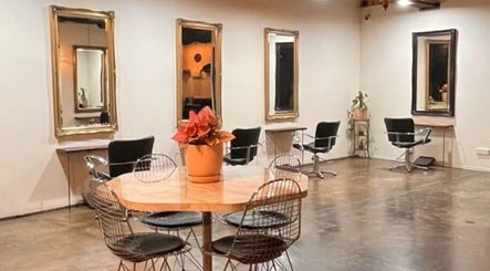 Elegant salon interior at Hair Maverick, Melbourne, Victoria, AU with chic chairs and mirrors.