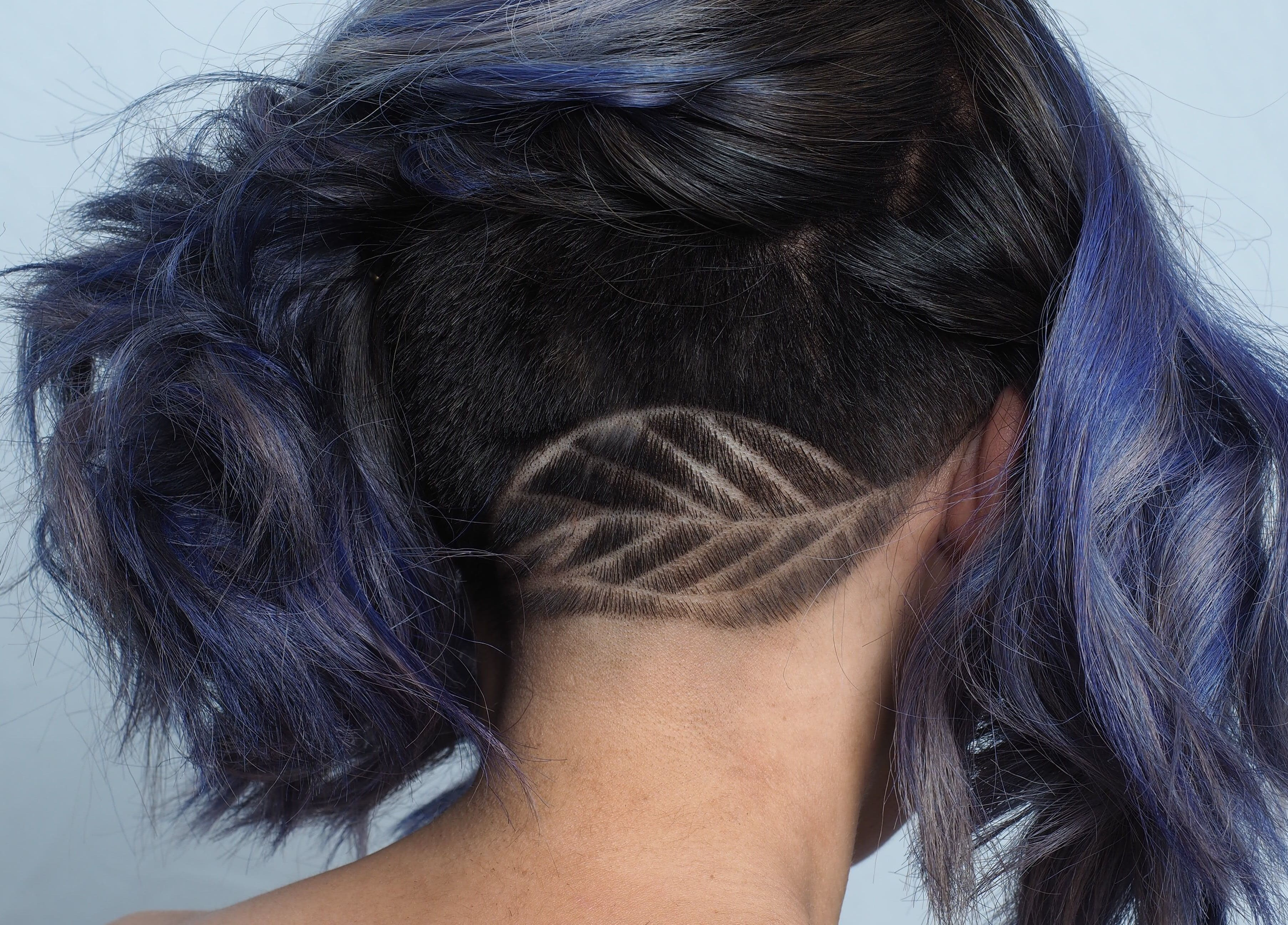 Creative undercut hairstyle with vibrant colors at Hair Maverick, Melbourne, Victoria, AU.