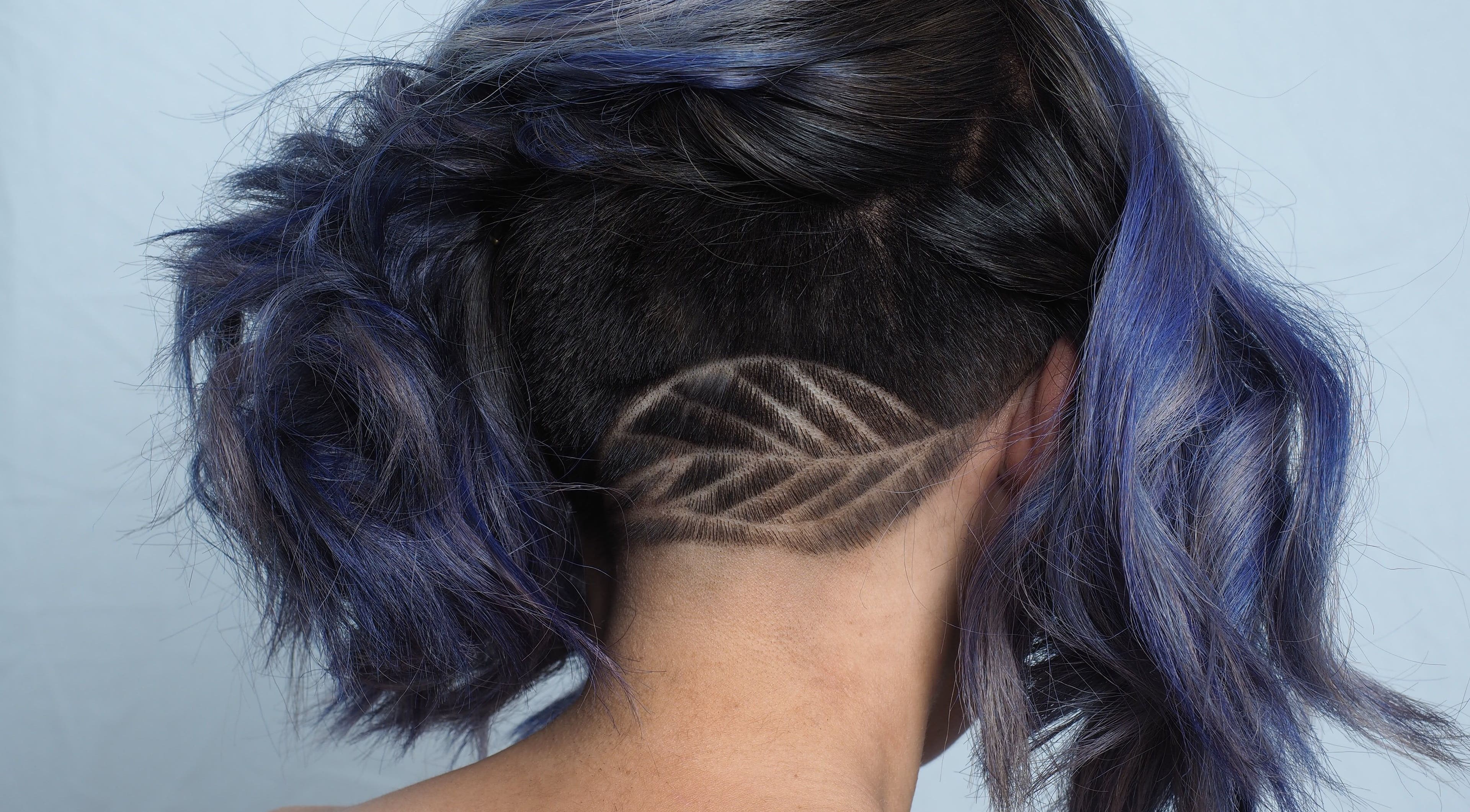 Creative undercut hairstyle with vibrant colors at Hair Maverick, Melbourne, Victoria, AU.