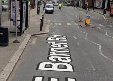 Street view near Deli White Massage MOOD in London, England, GB with a busy road and shops.