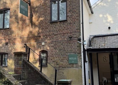 Brick exterior of Deli White Massage RITUAL in Berkhamsted, England, GB, with steps leading to entrance.