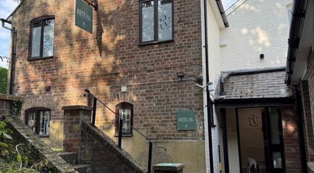 Brick exterior of Deli White Massage RITUAL in Berkhamsted, England, GB, with steps leading to entrance.