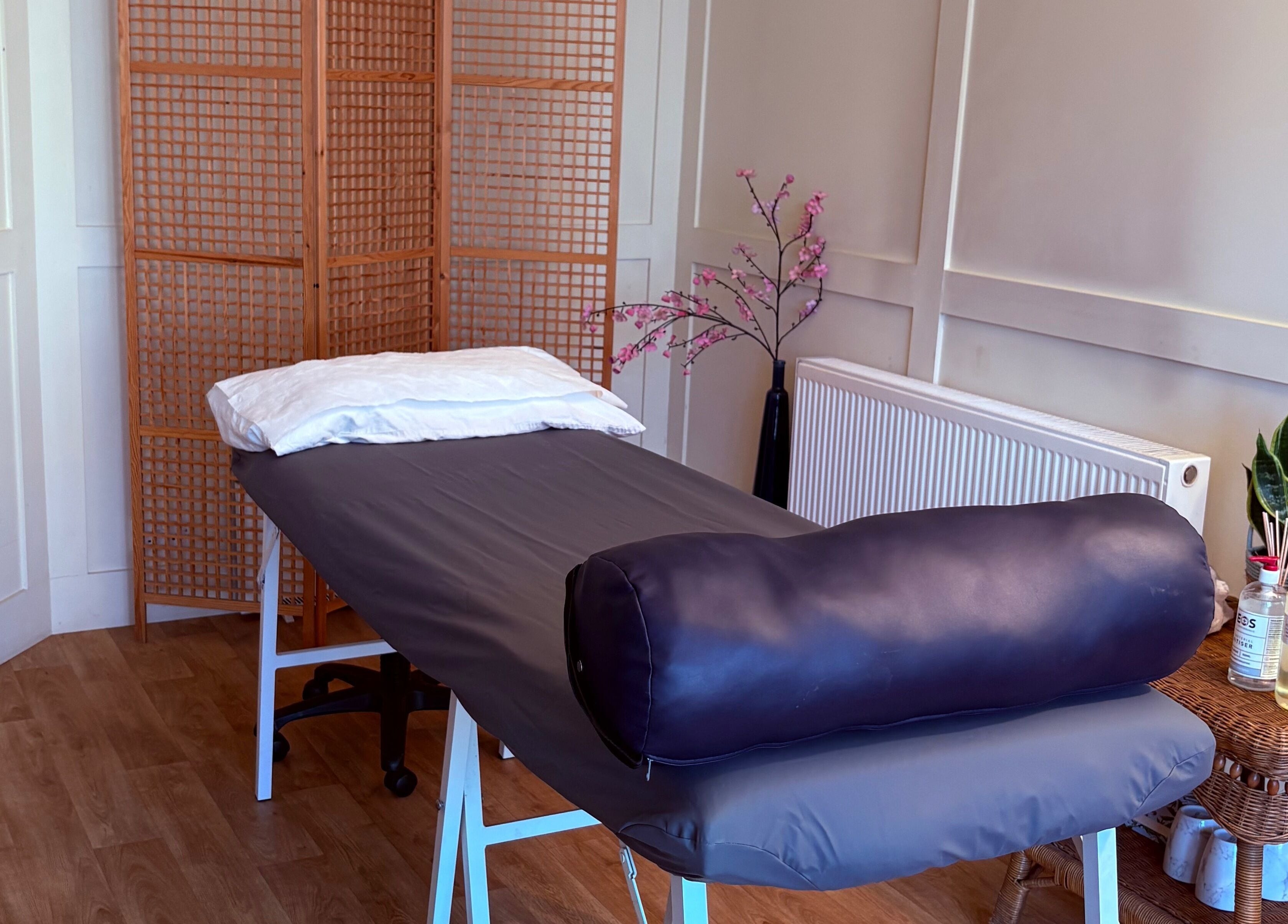 Serene treatment room at Kaizen Clinic, Haslemere, England, GB with massage bed and relaxing decor.