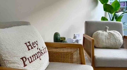 Cozy seating with pumpkin decor at Iz Does Nails, Todmorden, England, GB creates a welcoming ambiance.