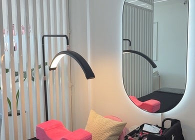Modern beauty area at Lush&luxe studio, Accra, with mirror, sleek lighting, and comfy setup.