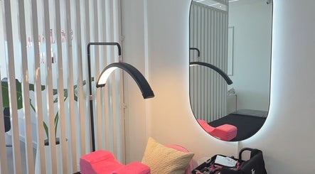 Modern beauty area at Lush&luxe studio, Accra, with mirror, sleek lighting, and comfy setup.