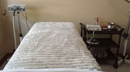 Massage bed and equipment at Queen R Spa in Johannesburg, Gauteng, ZA, offering a serene wellness experience.
