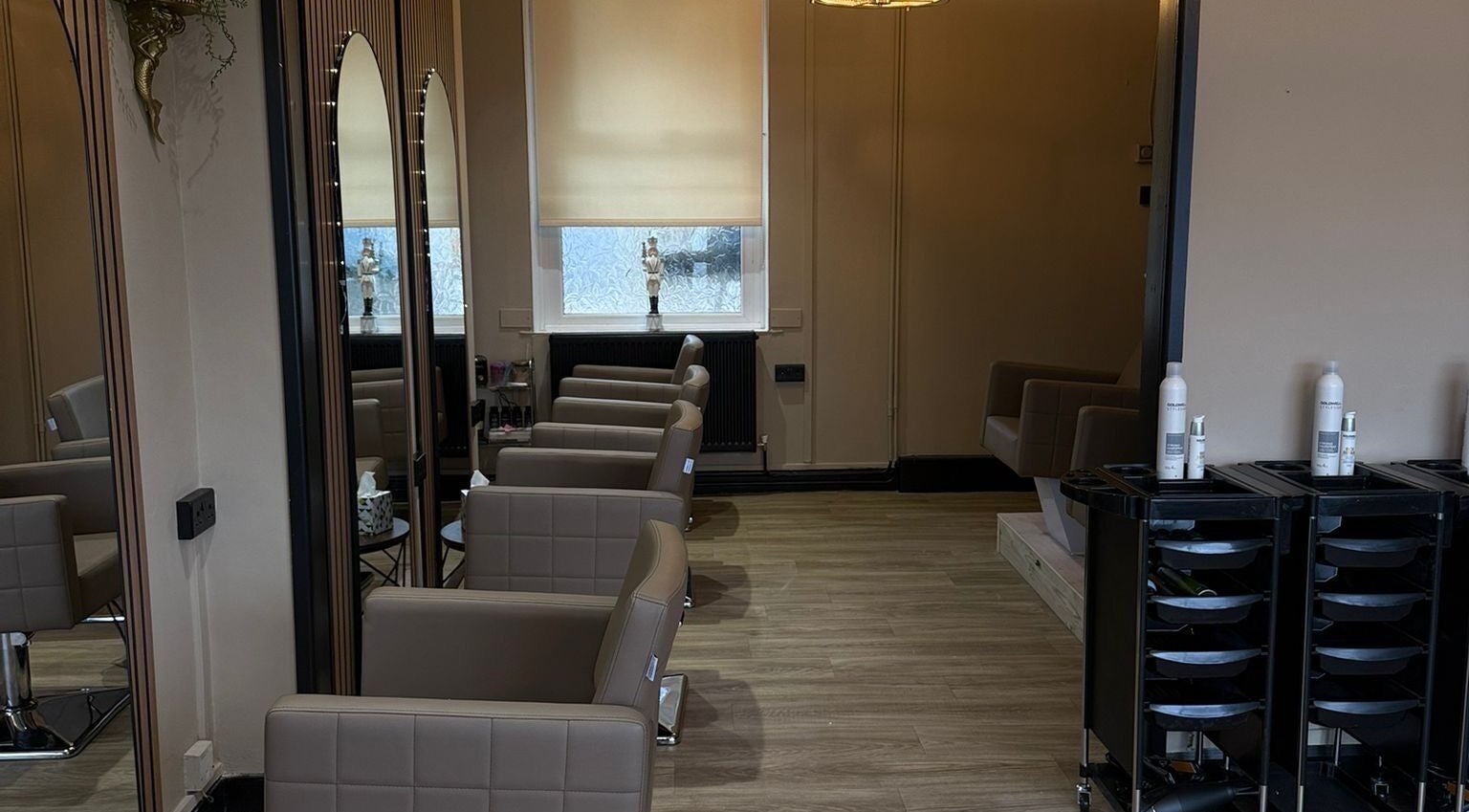 Cozy interior of The Hair Edit, Tre-boeth, Wales, GB with stylish salon chairs and mirrors.