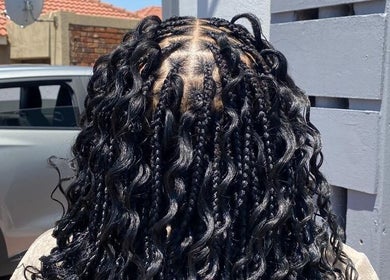Luxurious braided hairstyle at Aura's Aesthetics, Pretoria, Gauteng, ZA, showcasing intricate detail and style.