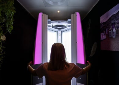 Tanning booth in Glow Studio, Roodepoort, Gauteng, ZA, with a person entering for a session.