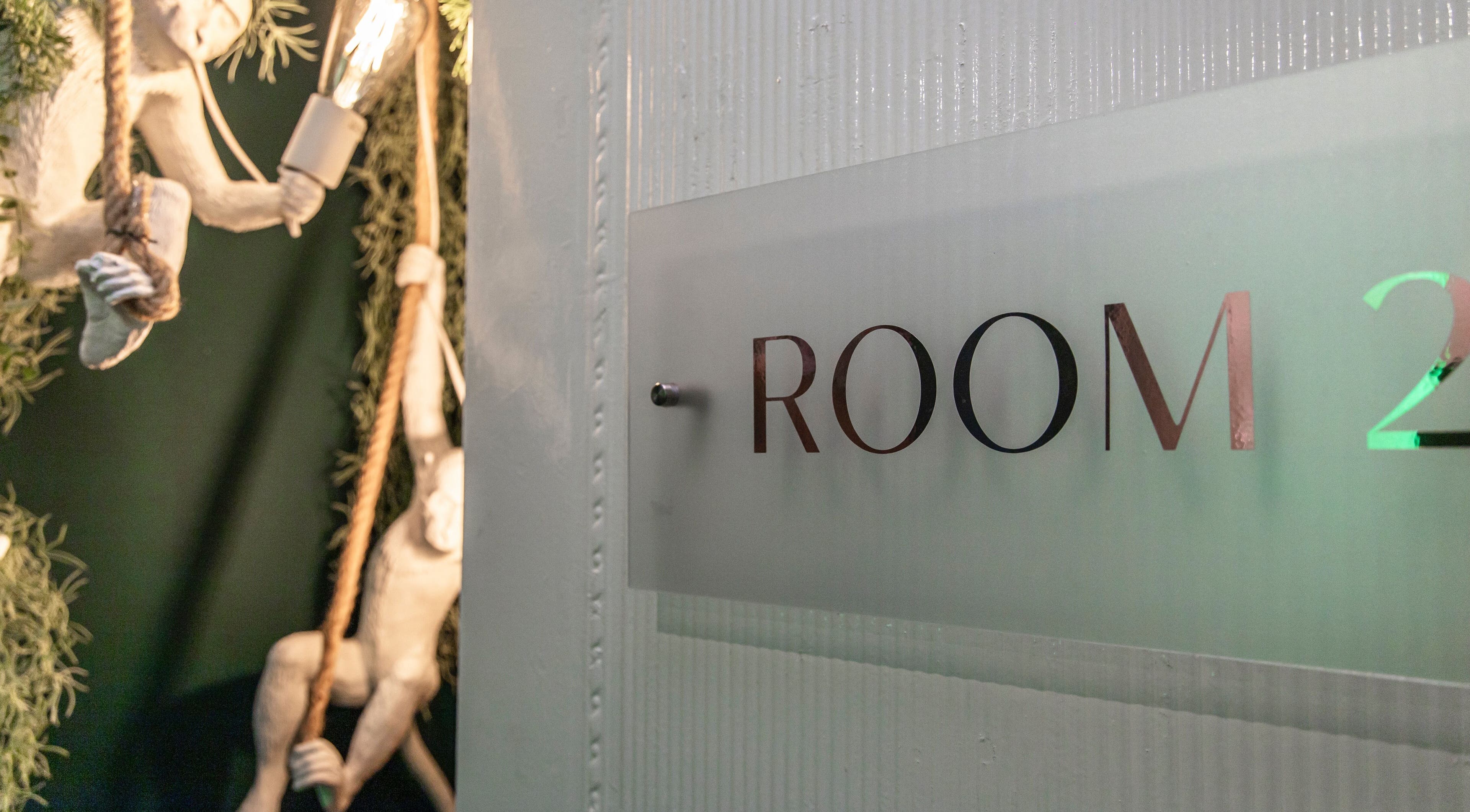 Charming decor with monkey sculptures at Glow Studio in Room 2, Roodepoort, Gauteng, ZA.