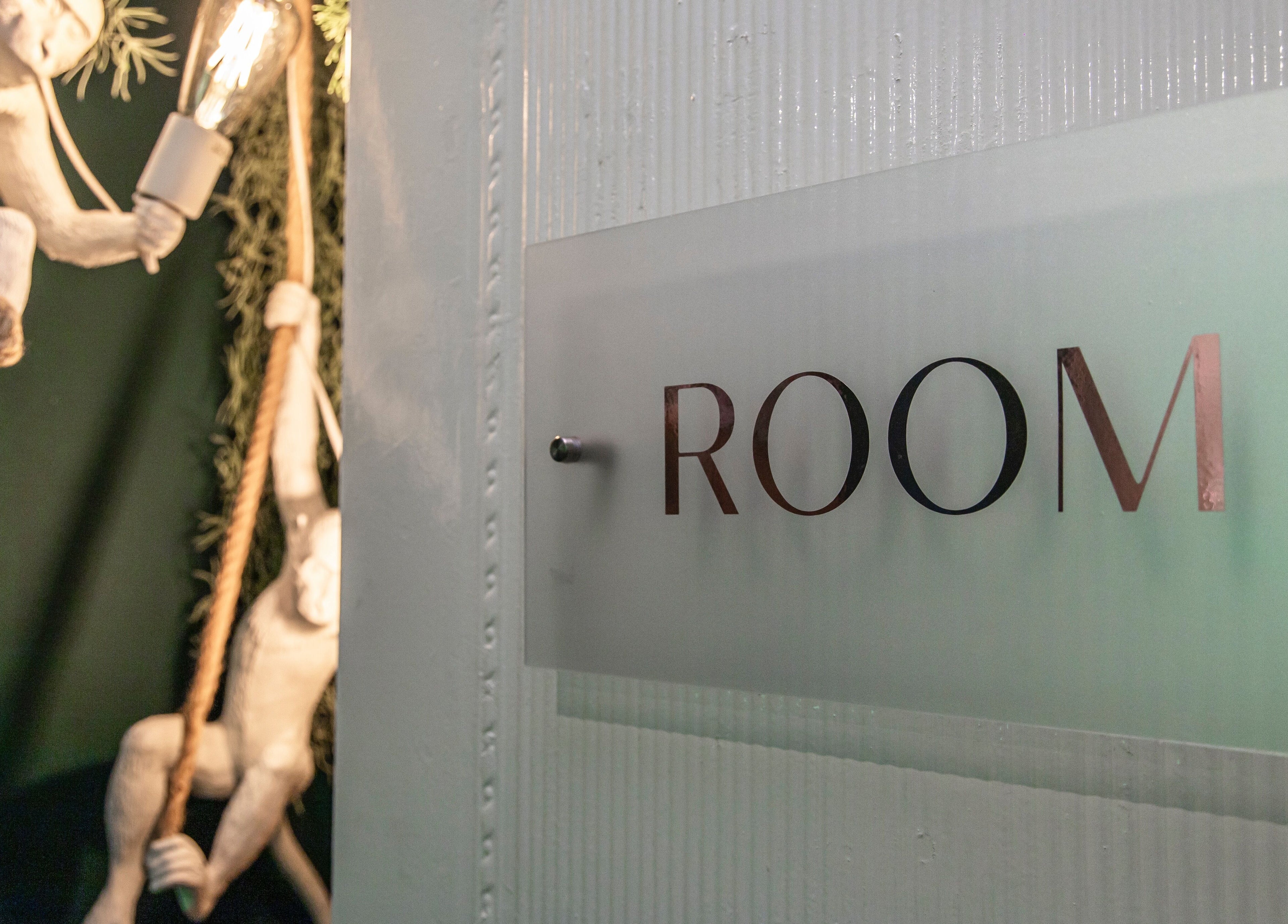 Entrance sign to Room 2 with artistic monkey decor at Glow Studio in Roodepoort, Gauteng, ZA.