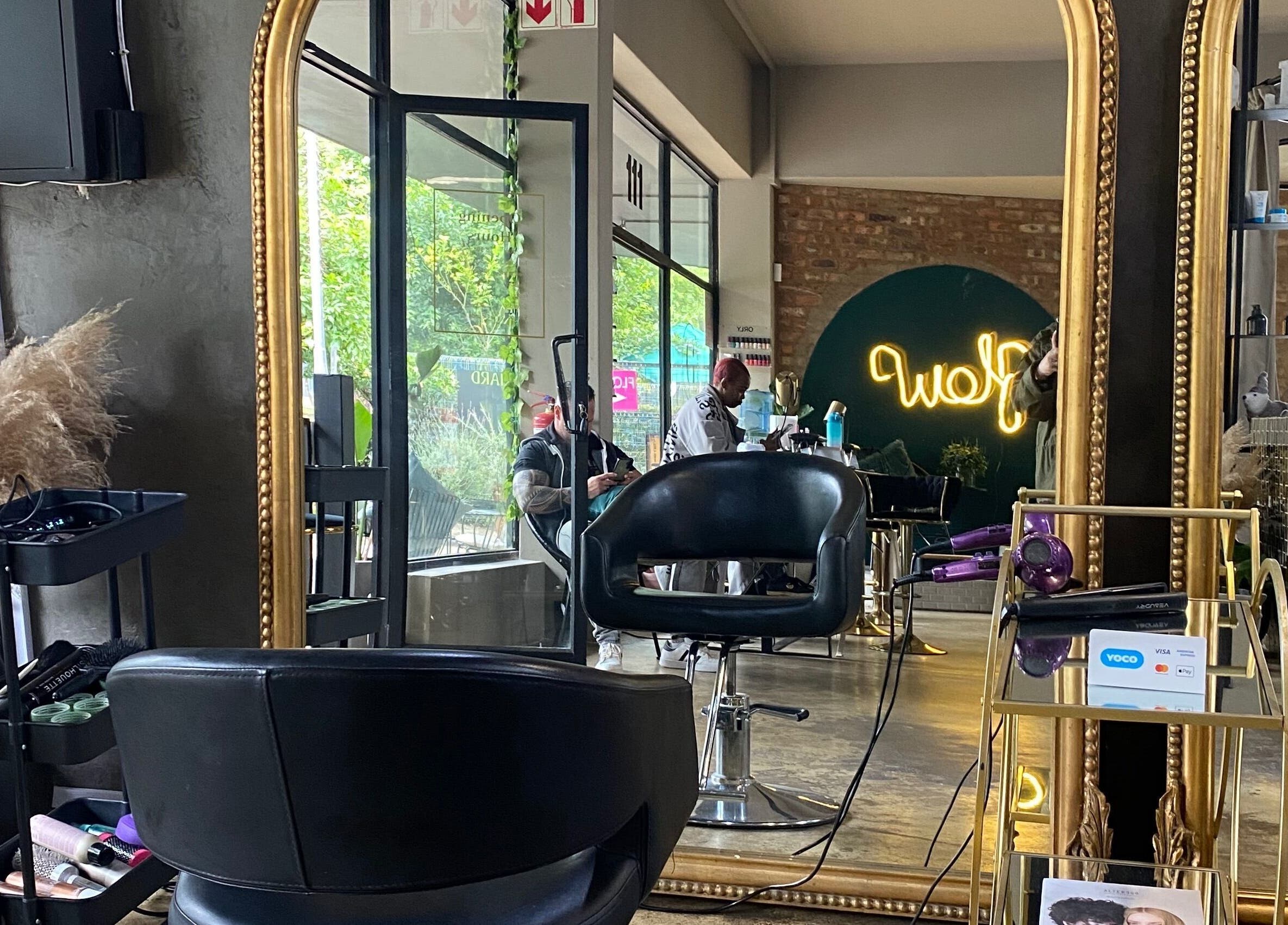 Luxurious salon interior at Roxy At Glow, Pretoria, Gauteng, ZA showcasing a stylish mirror and chair setup.