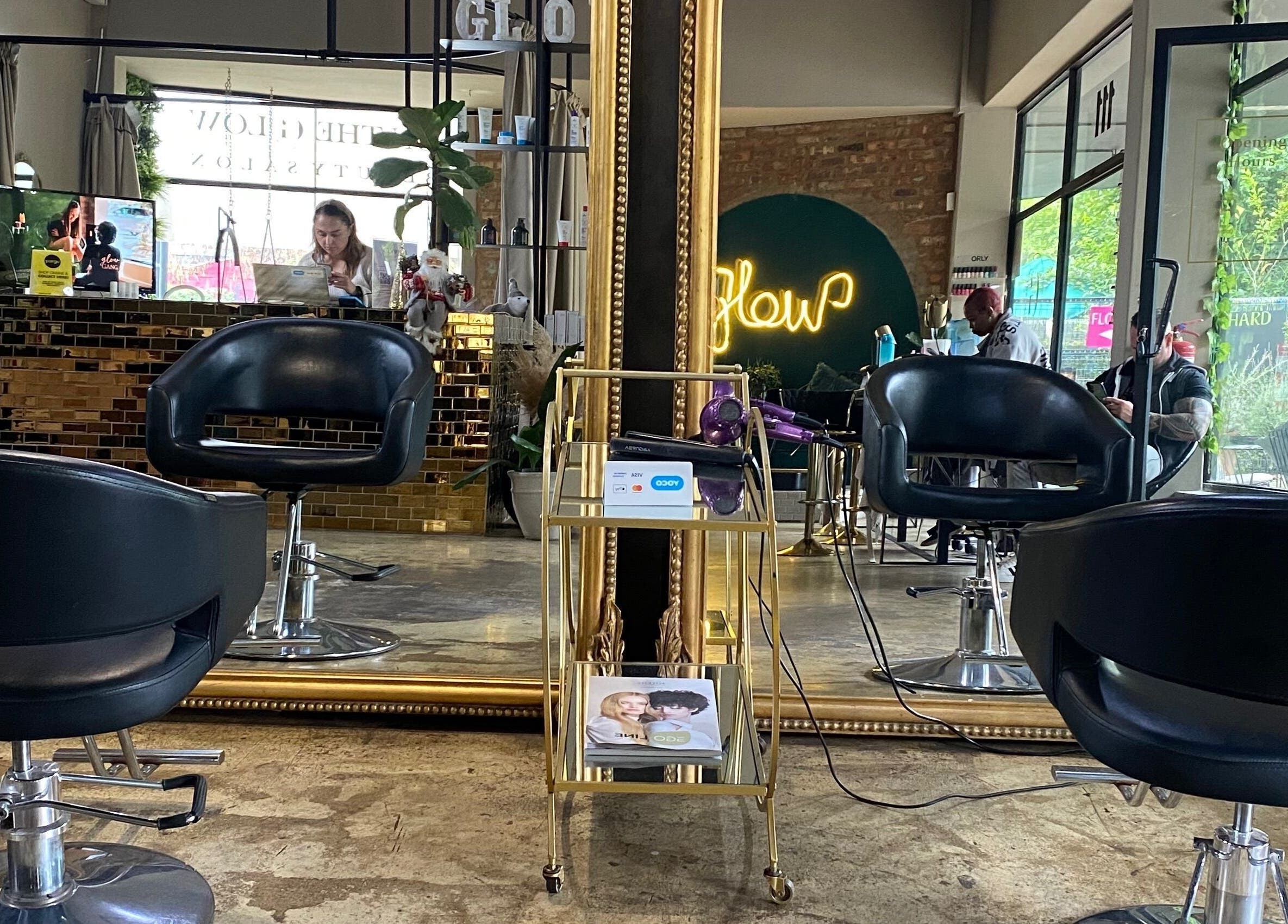 Stylish interior of Roxy At Glow in Pretoria, Gauteng, ZA with elegant black chairs and golden mirrors.