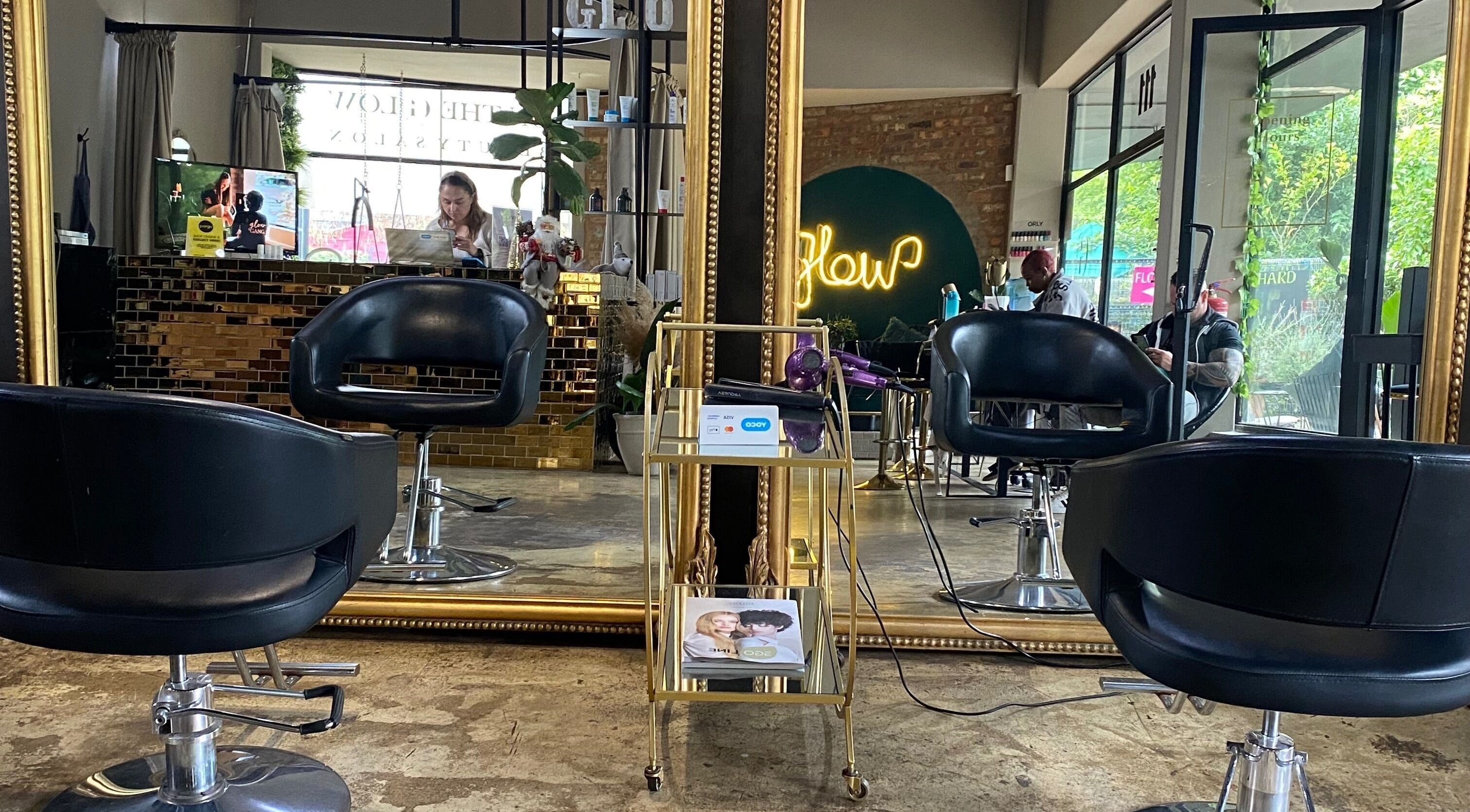 Stylish interior of Roxy At Glow in Pretoria, Gauteng, ZA with elegant black chairs and golden mirrors.