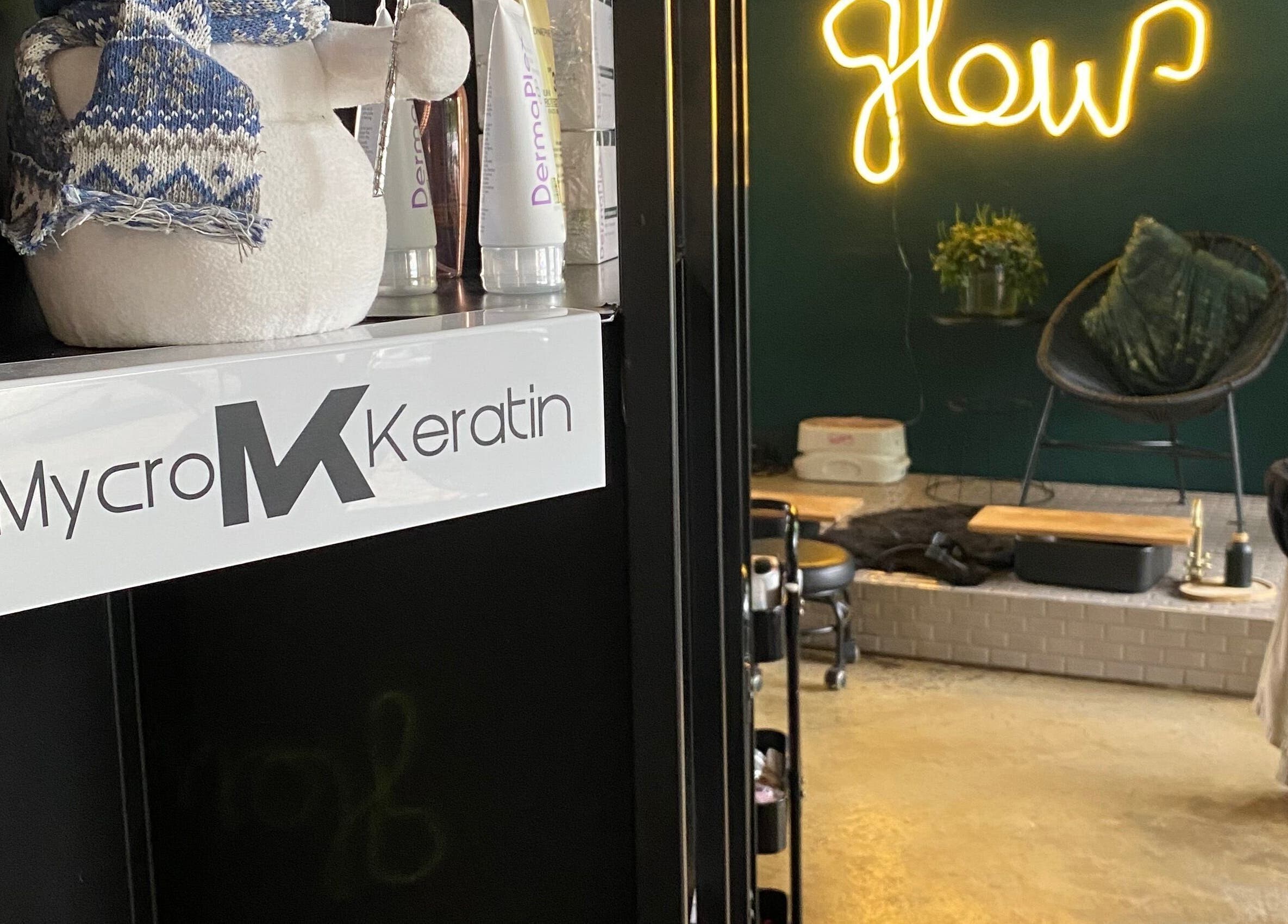 Roxy At Glow in Pretoria, Gauteng, ZA, showcasing a cozy lounge area with neon 'Glow' sign and MycroKeratin display.