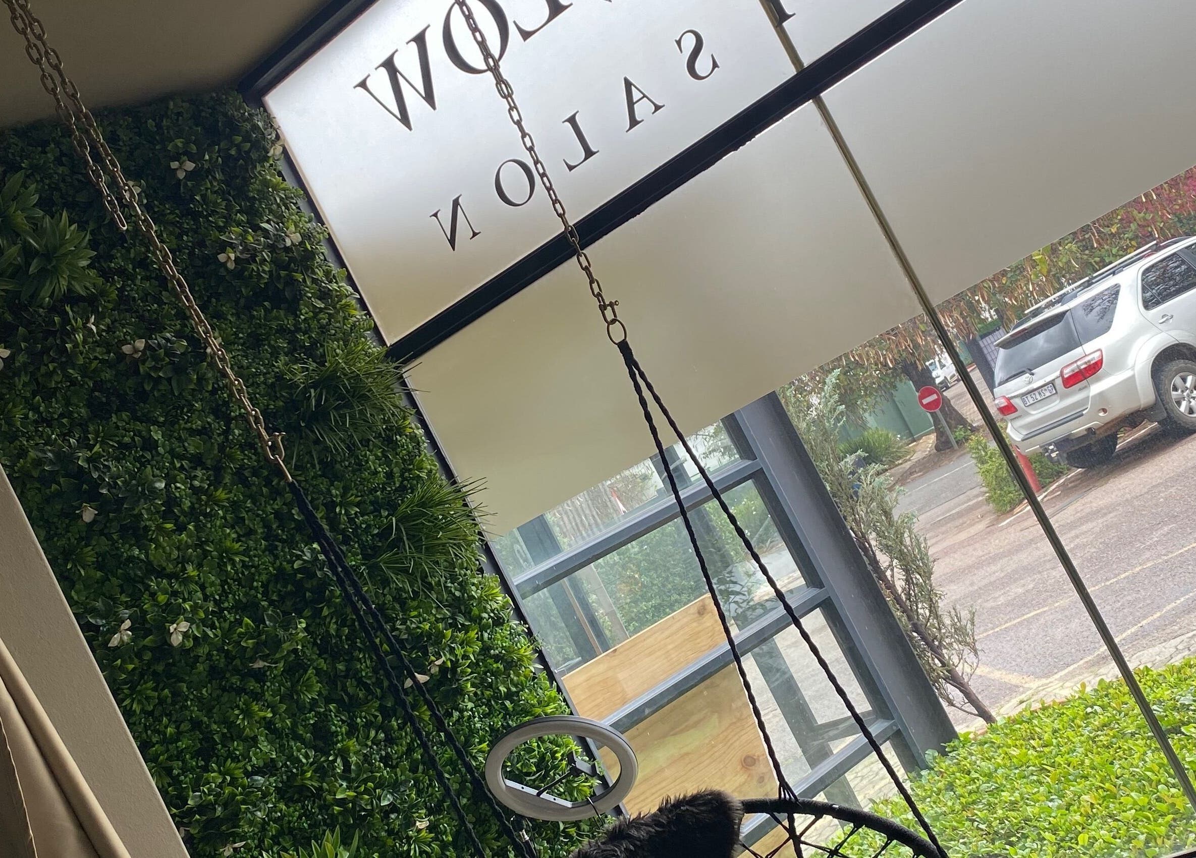 Roxy At Glow, Pretoria features a lush green wall and swing chair overlooking the parking area.