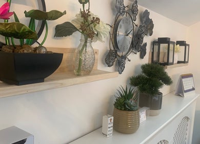Elegant decor at Nails By Vya, Douglas, Onchan, IM featuring plants and a stylish clock.