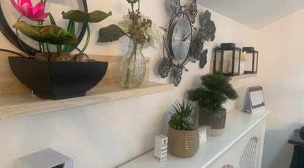 Elegant decor at Nails By Vya, Douglas, Onchan, IM featuring plants and a stylish clock.