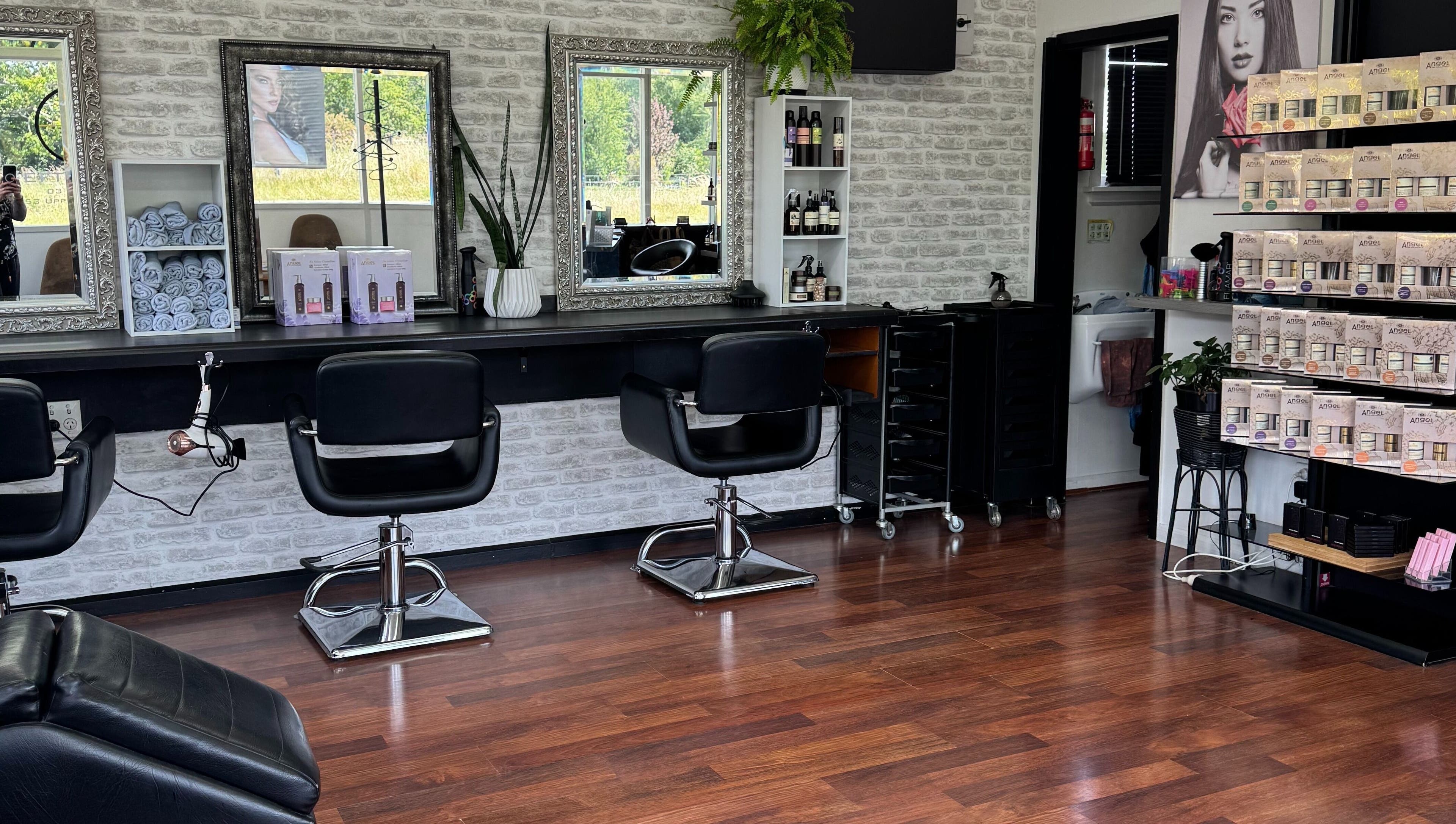 Elegant interior of Sefton Hair, Sefton, Canterbury Region, NZ with styling stations and products.