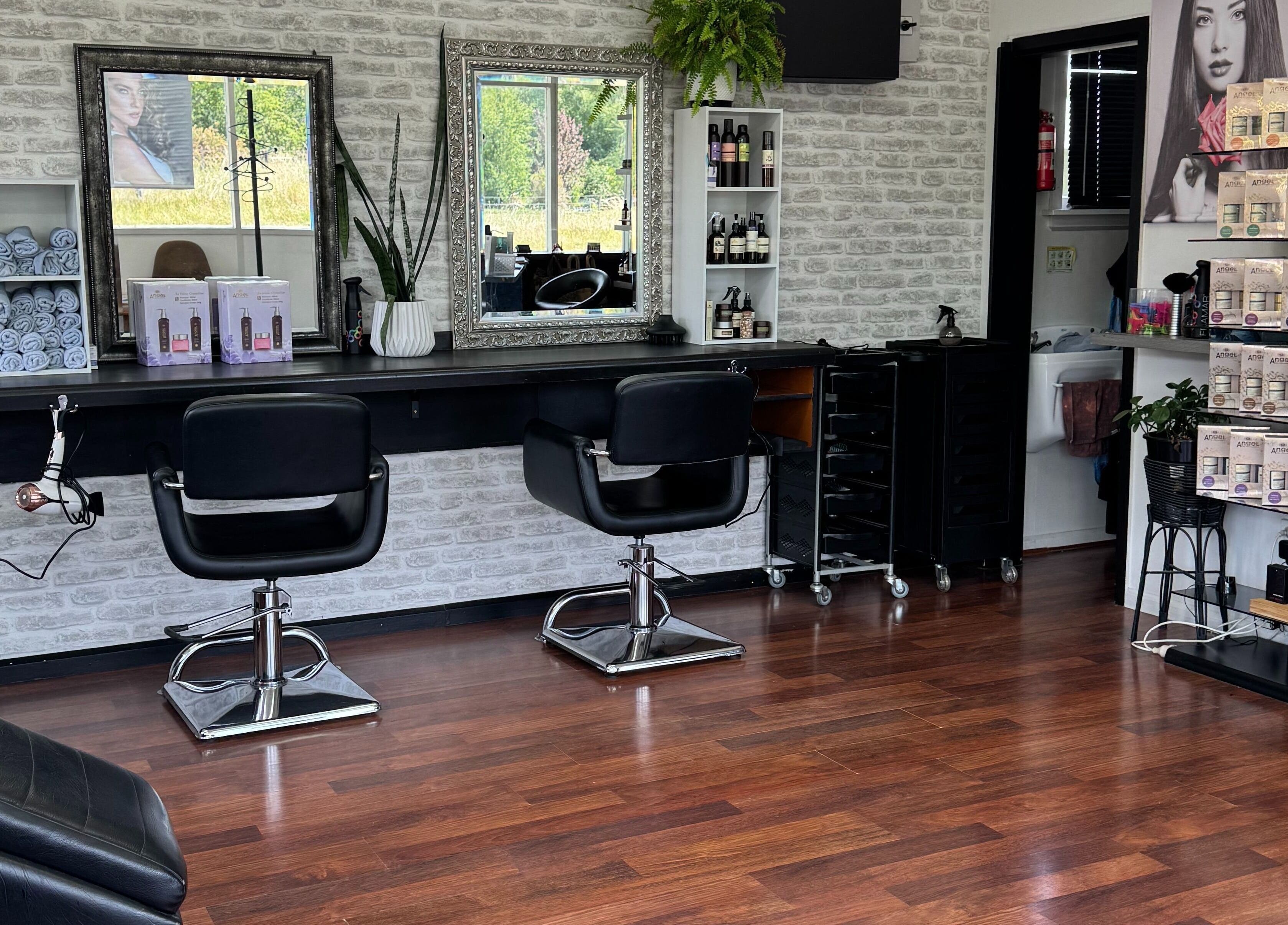 Elegant interior of Sefton Hair, Sefton, Canterbury Region, NZ with styling stations and products.