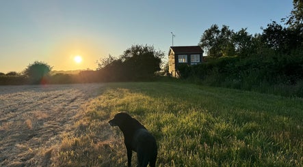 Golden sunset at Signal Box Reflexology in Holt, England, GB with rustic charm and peaceful fields.
